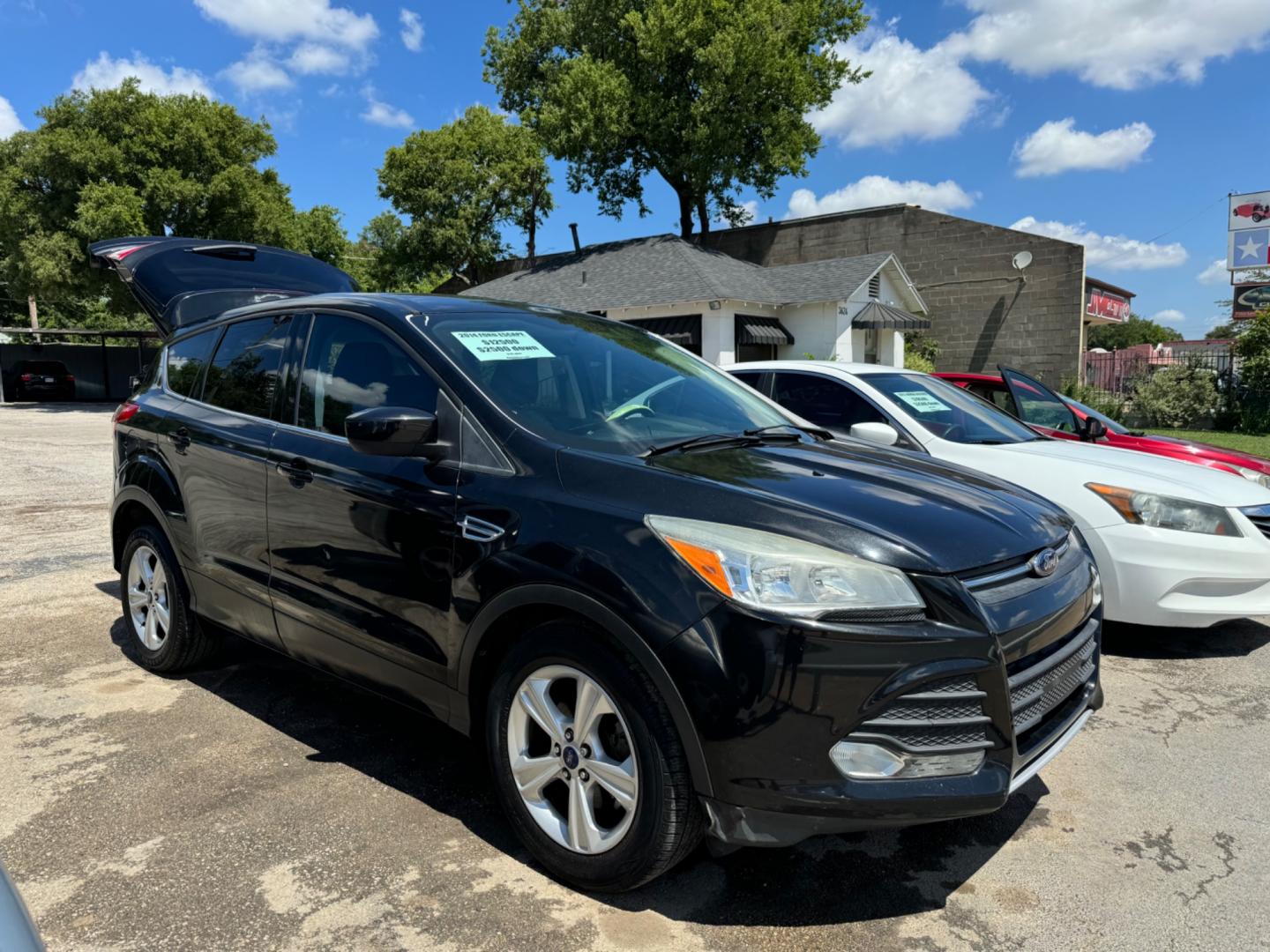 2014 Black Ford Escape SE FWD (1FMCU0GX7EU) with an 1.6L L4 DOHC 16V engine, Automatic transmission, located at 3624 Hemphill St., Fort Worth, TX, 76110, (817) 926-8921, 32.696205, -97.331985 - Photo#0